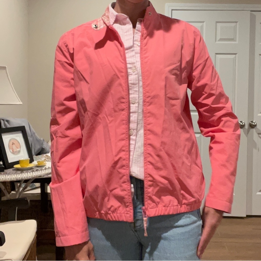 Light pink jacket, rain coat without hood.